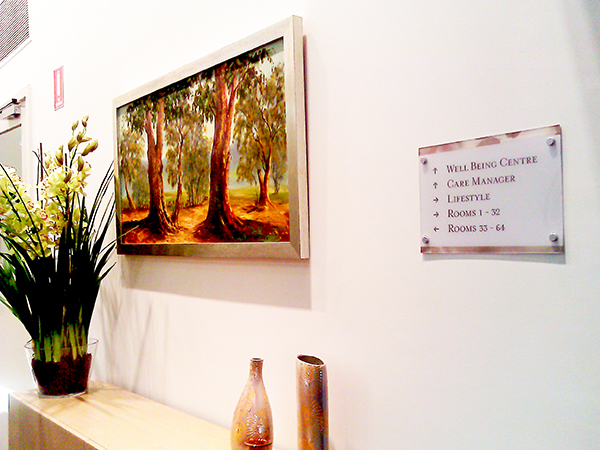 wall with painting and room locator signage